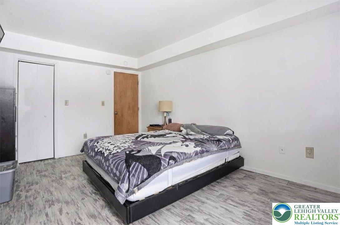 3301 Windermere Drive Bushkill, PA 18324 - Photo 20 of 71 a bedroom with a bed and wooden floor