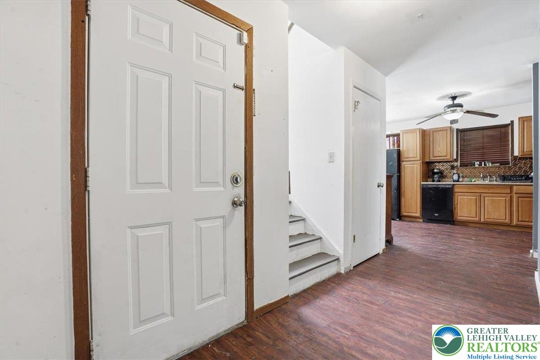 3301 Windermere Drive Bushkill, PA 18324 - Photo 24 of 71 an empty room with wooden floor and a kitchen