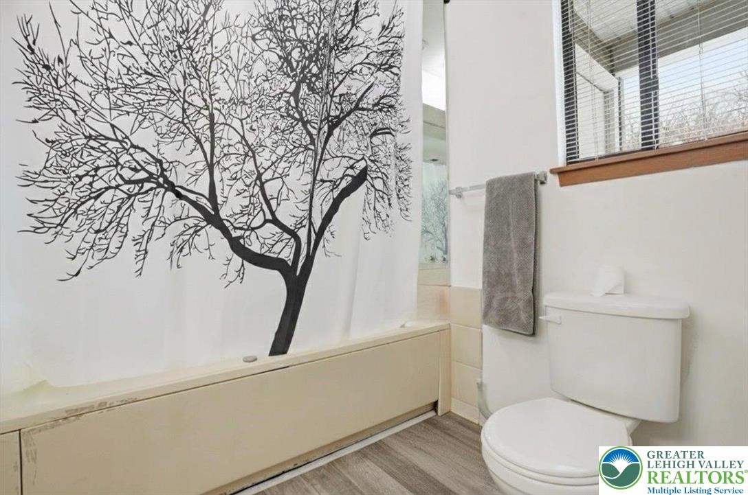 3301 Windermere Drive Bushkill, PA 18324 - Photo 36 of 71 a white toilet sitting next to a shower and a sink