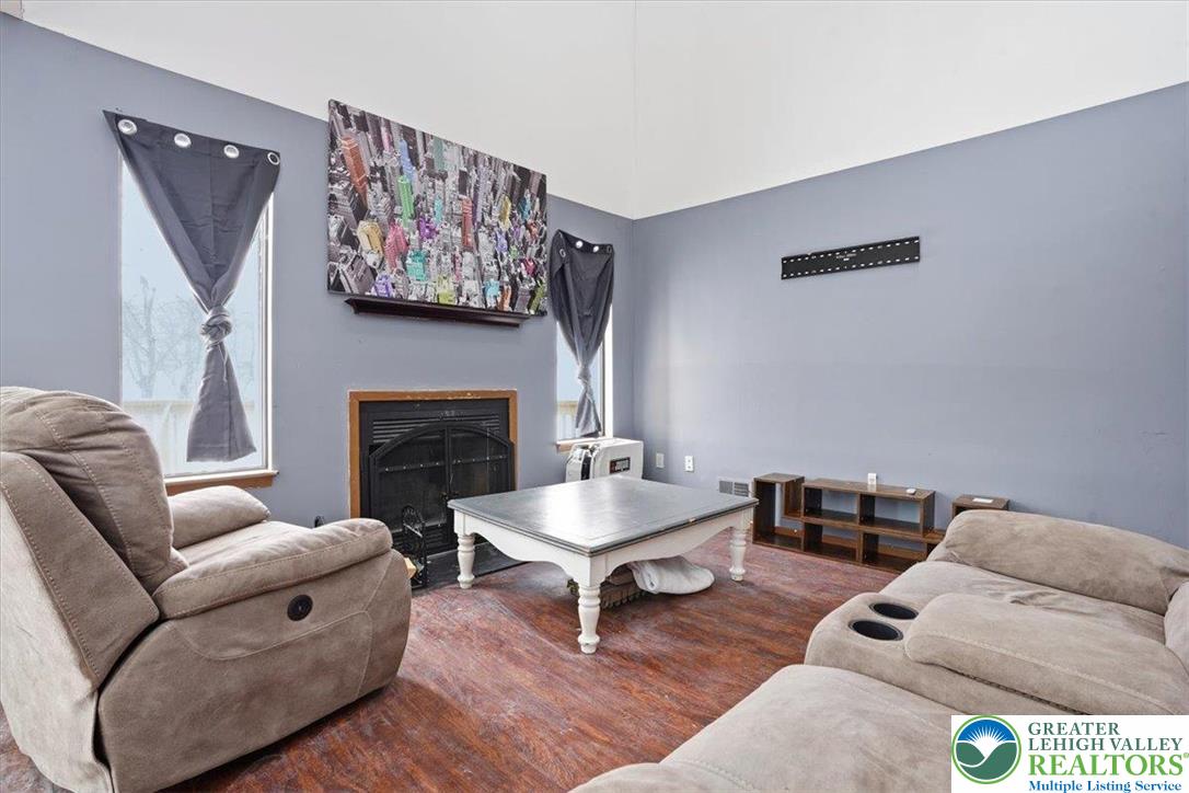 3301 Windermere Drive Bushkill, PA 18324 - Photo 5 of 71 a living room with furniture a rug and a fireplace