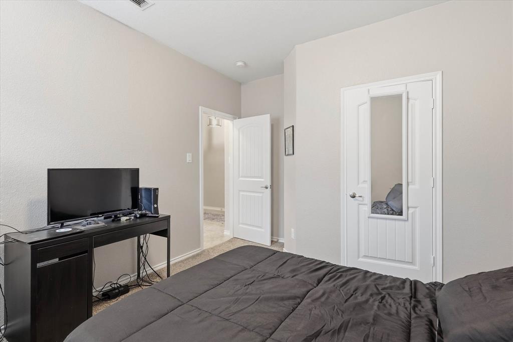 11500 Starlight Ranch Fort Worth, TX 76052 - Photo 25 of 40 Bedroom featuring light-colored walls, carpeted flooring, and a white interior door