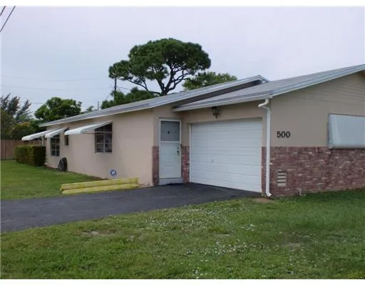 a view of a backyard with plants and a garden