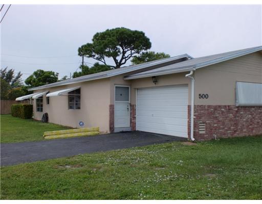 a view of a backyard with plants and a garden