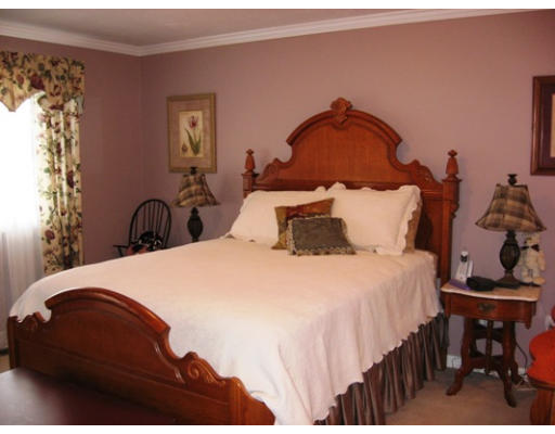 18 A Highfield Road, Unit 18A Charlton, MA 01507 - Photo 4 of 8 a bedroom with a bed and wooden floor