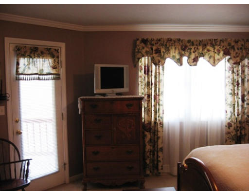 18 A Highfield Road, Unit 18A Charlton, MA 01507 - Photo 5 of 8 a bedroom with a bed and a flat tv screen on dresser