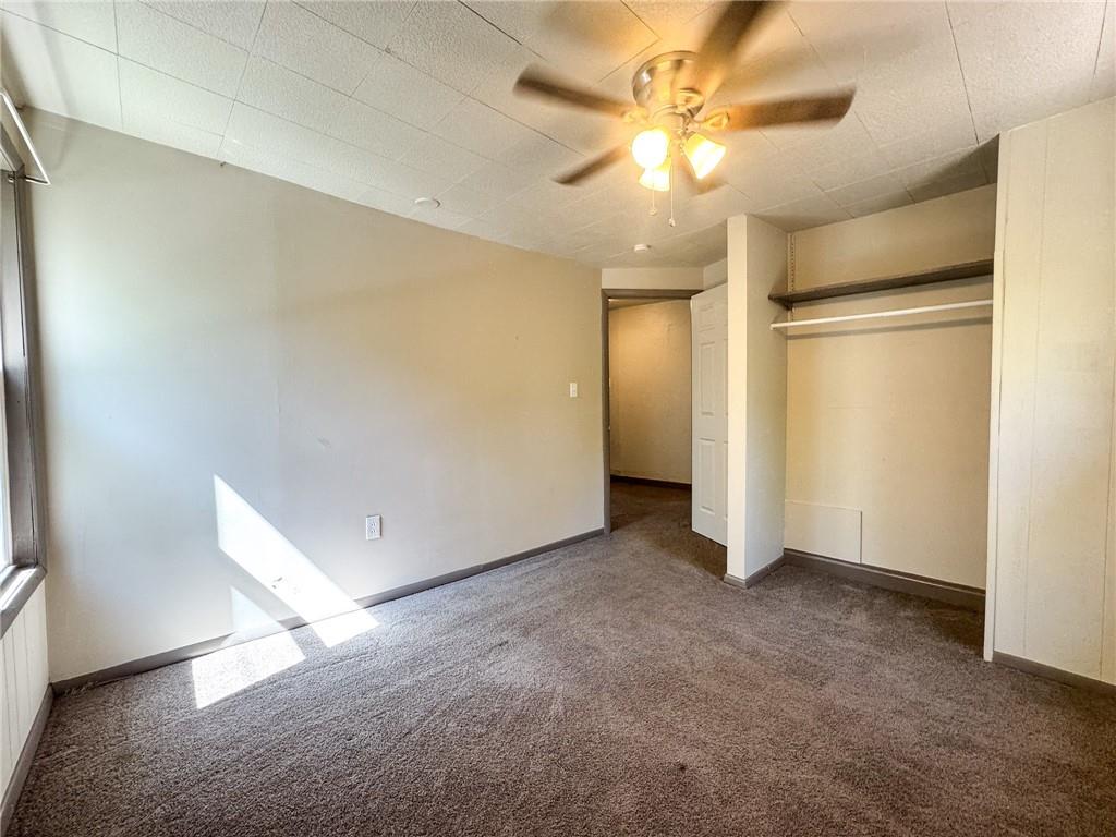 121 Heim Avenue Butler, PA 16001 - Photo 14 of 16 an empty room with a ceiling fan and carpet