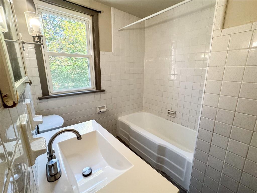121 Heim Avenue Butler, PA 16001 - Photo 15 of 16 a bathroom with a sink a toilet and a tub