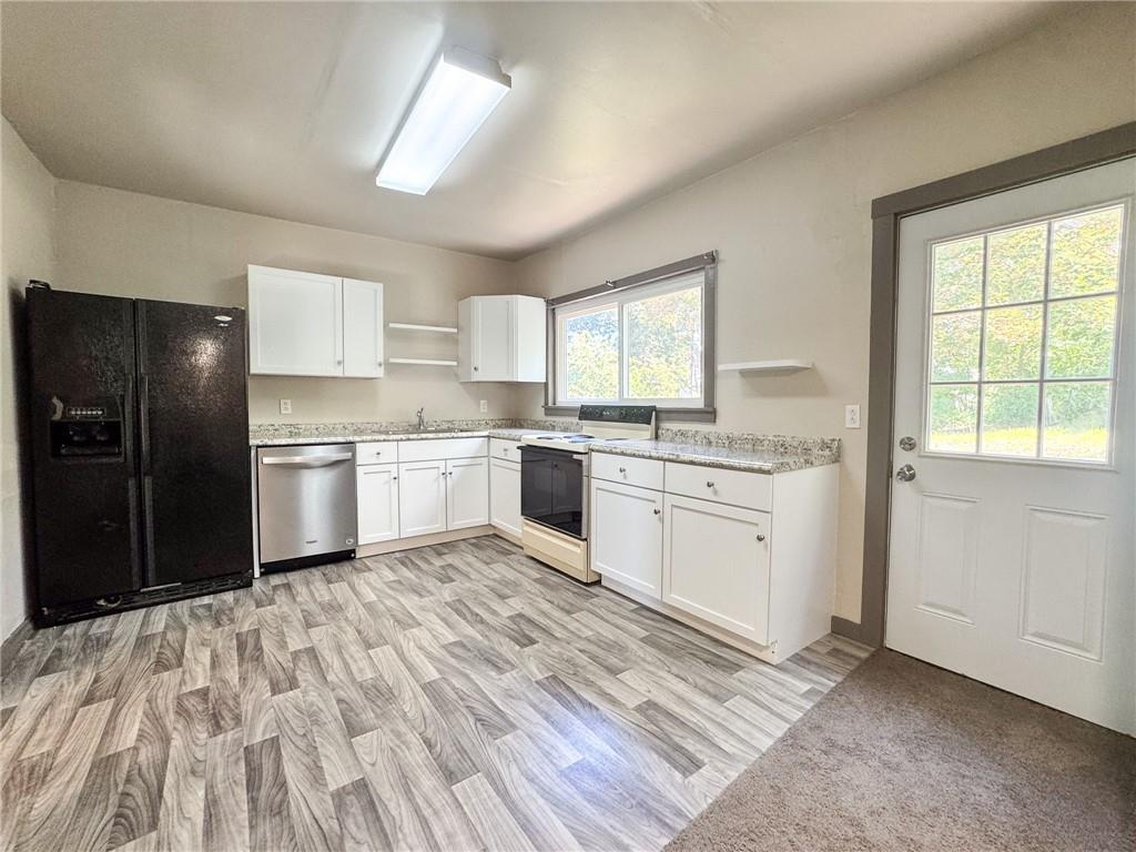 121 Heim Avenue Butler, PA 16001 - Photo 6 of 16 a kitchen with white cabinets appliances and window