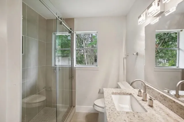 a bathroom with a sink toilet and shower