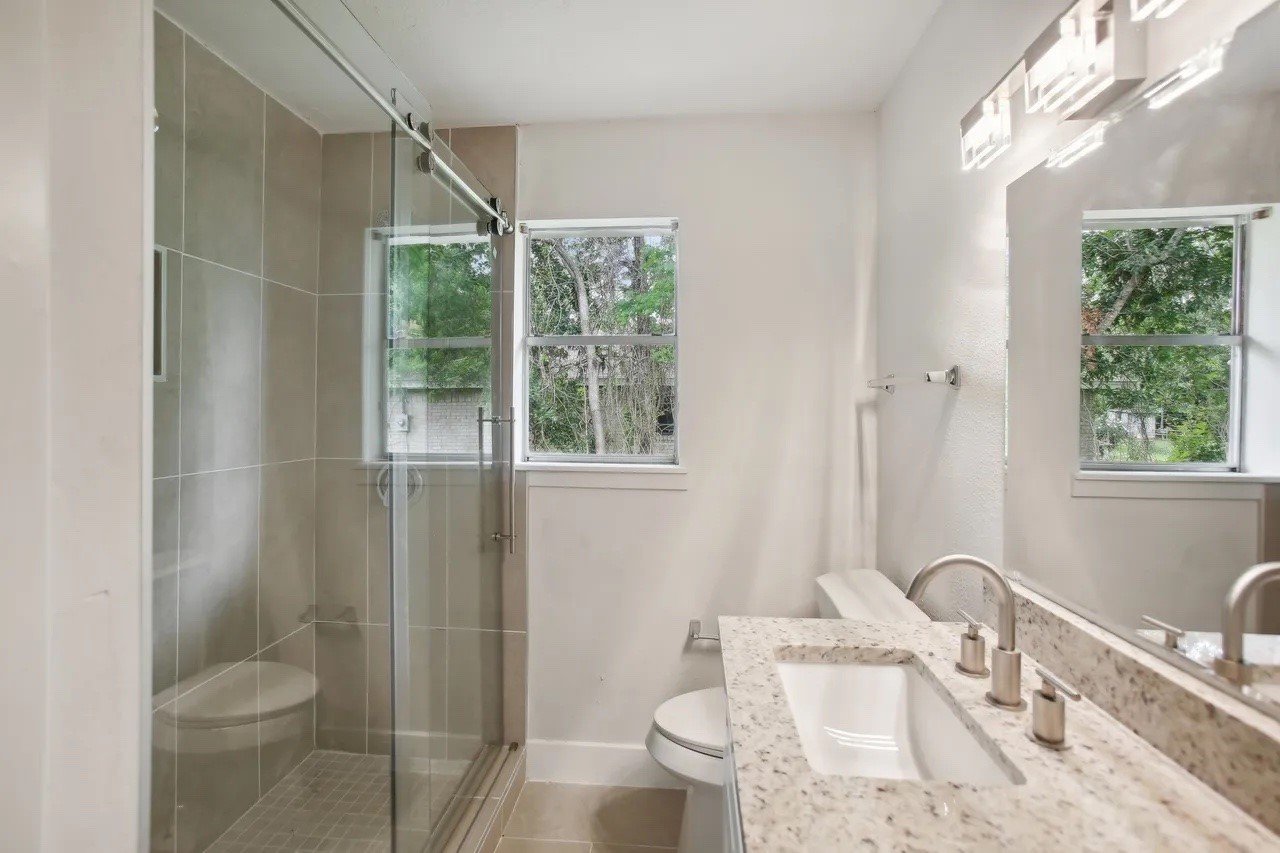 906 S Road Baytown, TX 77521 - Photo 13 of 32 a bathroom with a sink toilet and shower