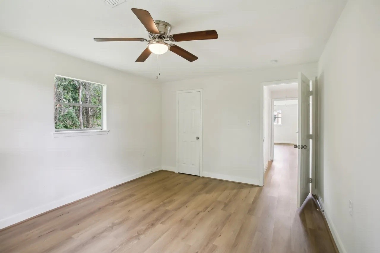 906 S Road Baytown, TX 77521 - Photo 19 of 32 a view of a big room with wooden floor closet and windows