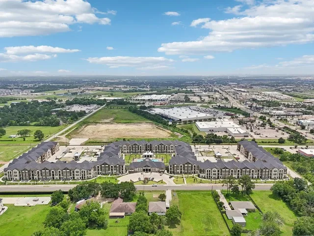 an aerial view of residential building and lake