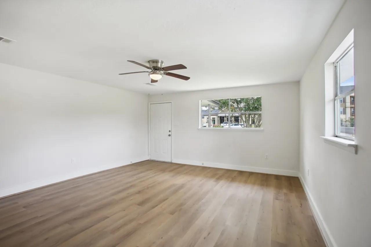 906 S Road Baytown, TX 77521 - Photo 3 of 32 an empty room with wooden floor and windows