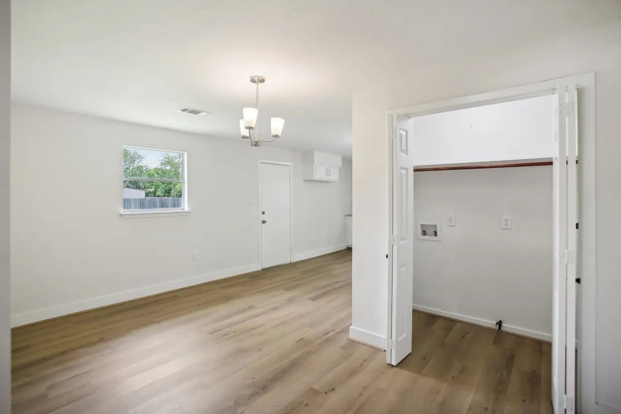 906 S Road Baytown, TX 77521 - Photo 6 of 32 an empty room with wooden floor and windows