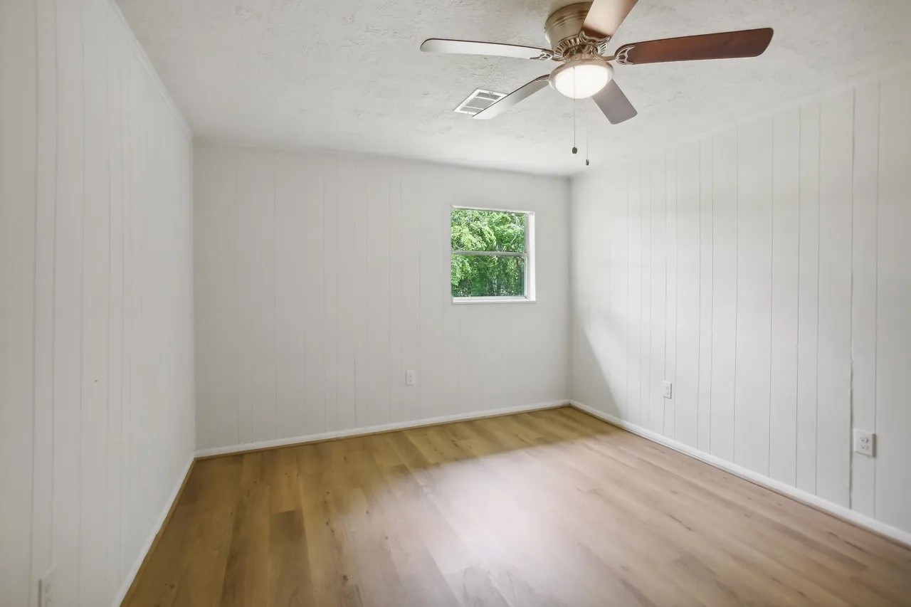 906 S Road Baytown, TX 77521 - Photo 10 of 32 an empty room with a window and a fan