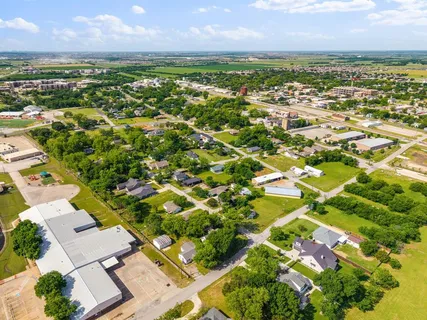 an aerial view of residential houses with outdoor space
