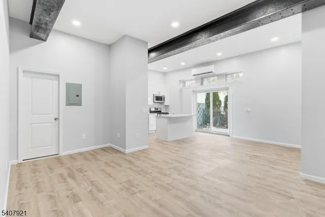 a view of a kitchen with refrigerator and a sink