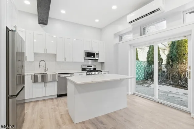 a kitchen with white cabinets and white appliances
