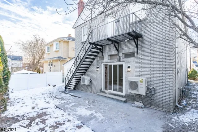 a view of a house with a yard and wooden fence