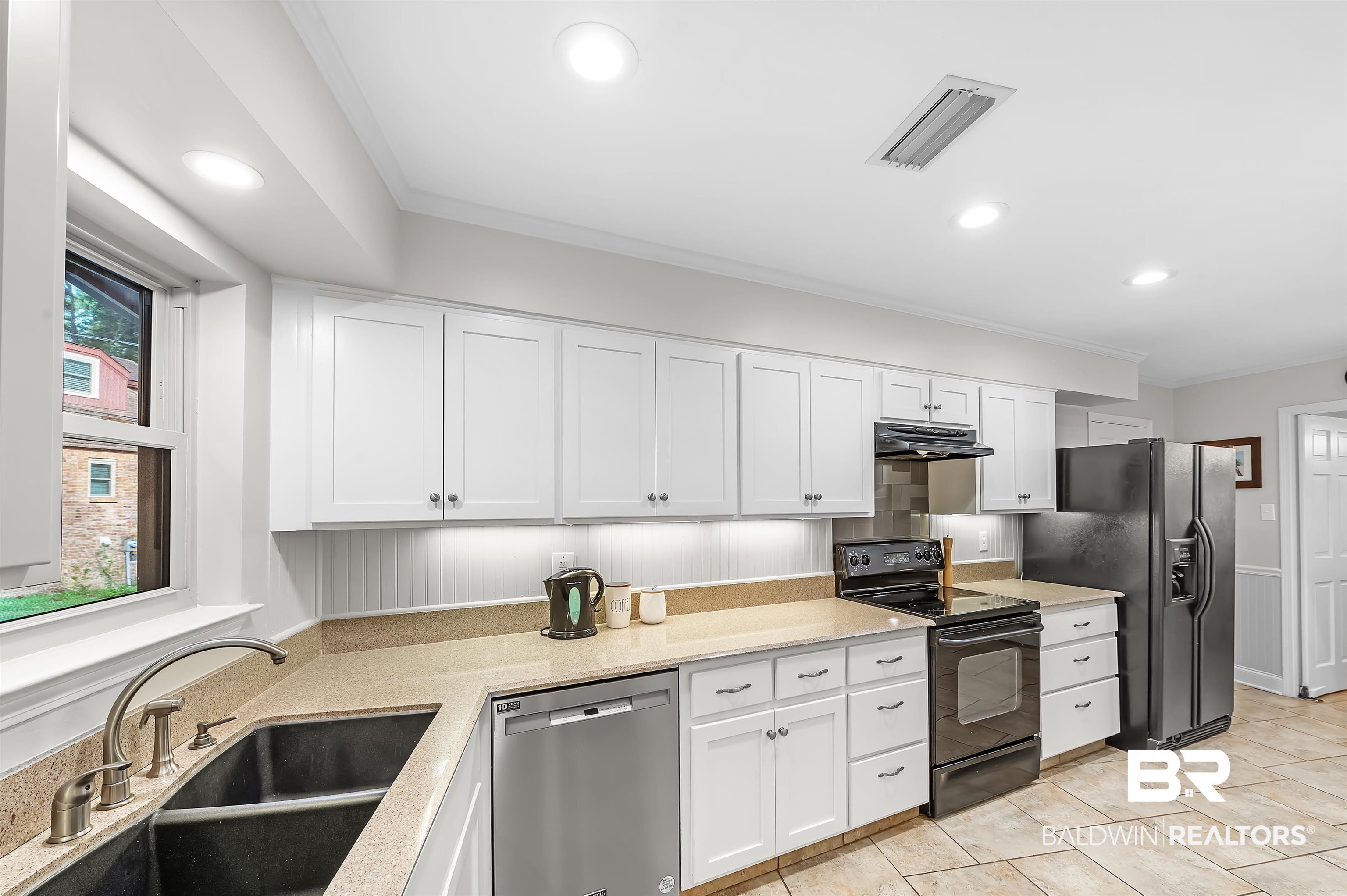 104 James Circle Daphne, AL 36526 - Photo 17 of 62 Kitchen with white cabinetry, black appliances, sink, and plenty of natural light