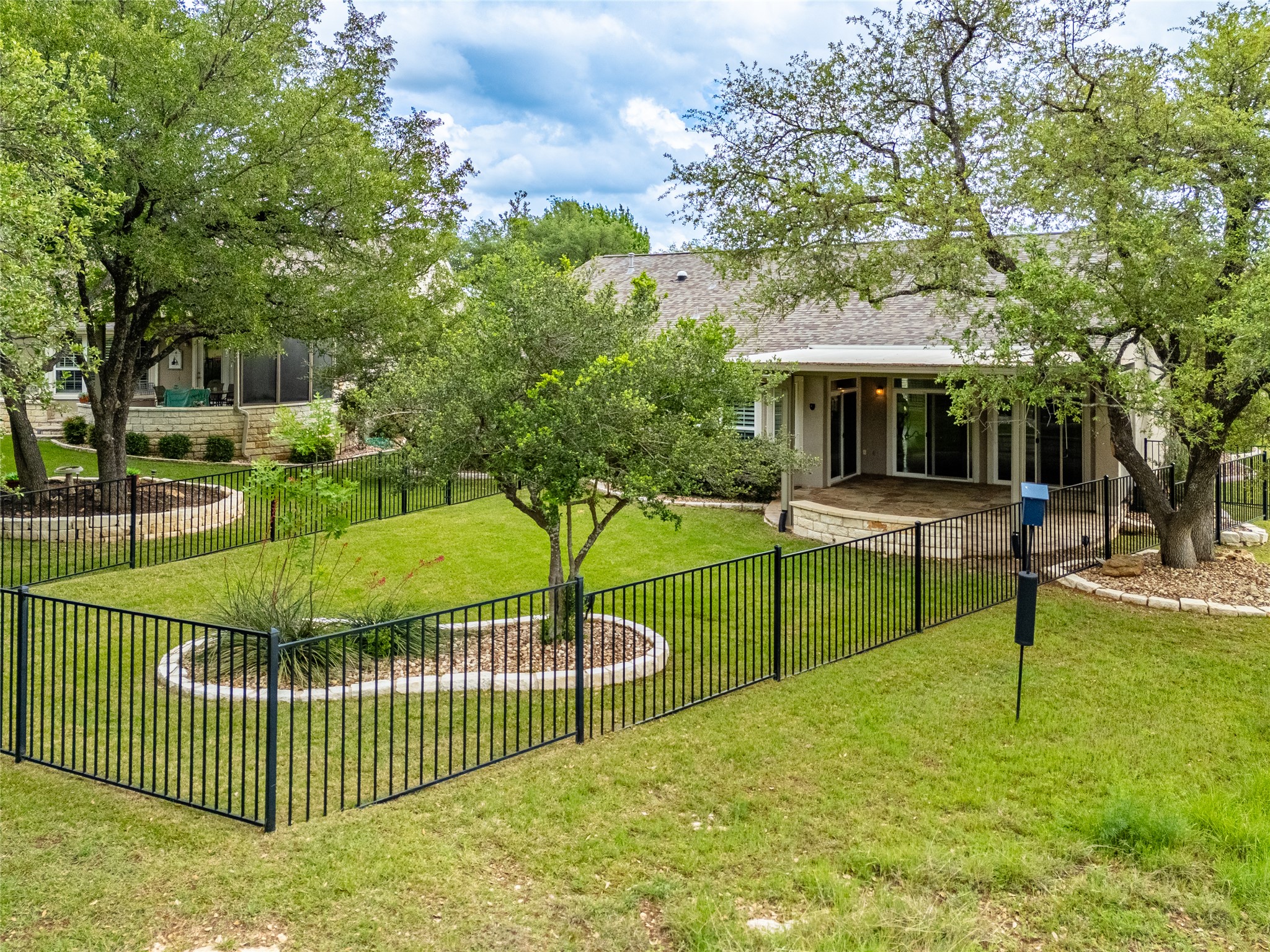 214 Summit Street Georgetown, TX 78633 - Photo 32 of 38 The property features a fenced yard with a lawn and mature trees