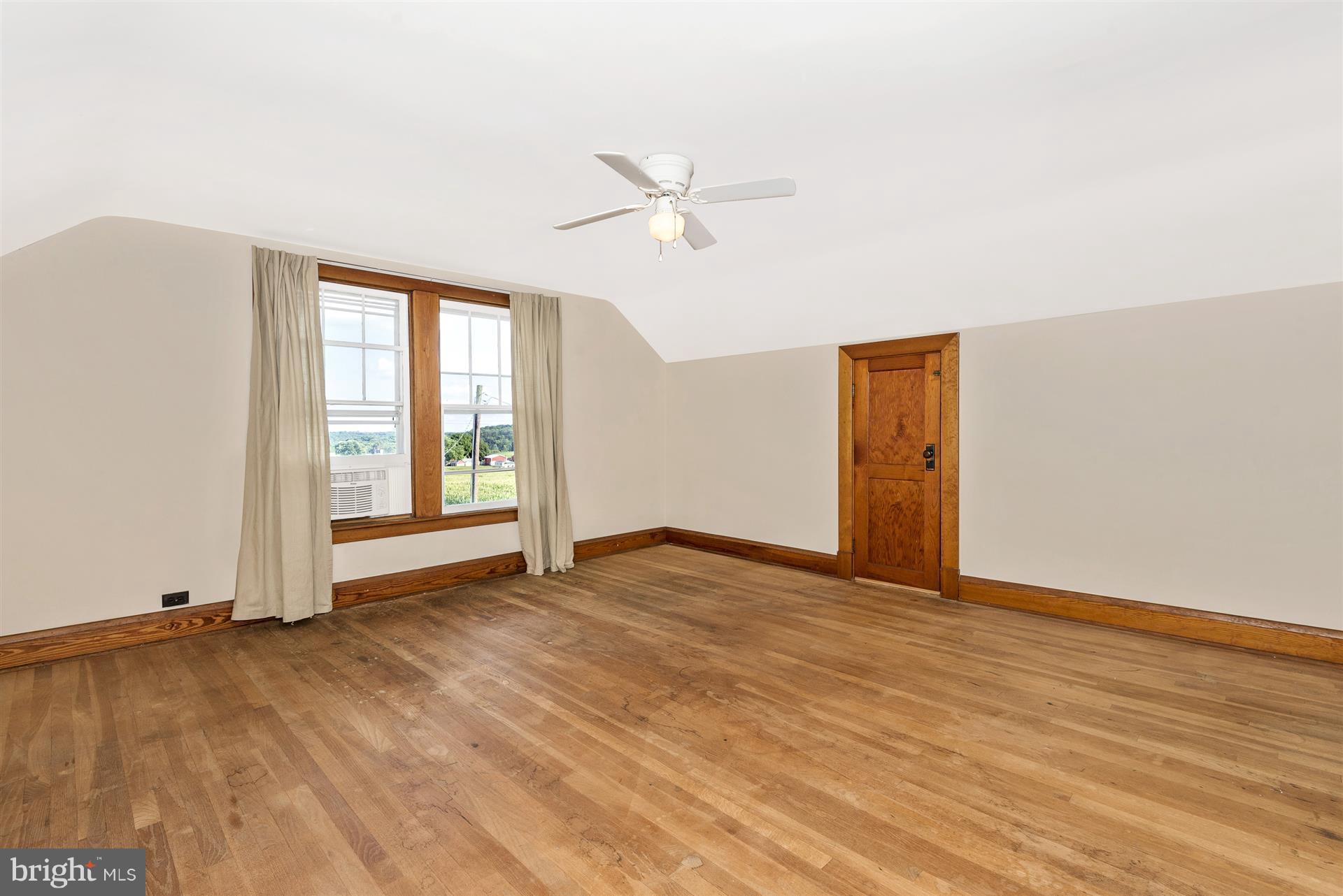 2601 Gillis Road Mount Airy, MD 21771 - Photo 20 of 29 an empty room with wooden floor fan and windows