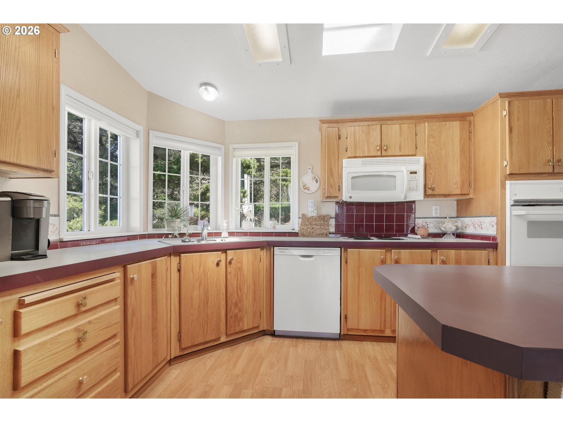 94033 Doyle Point Road Gold Beach, OR 97444 - Photo 12 of 42 a kitchen with stainless steel appliances granite countertop a stove a sink and a microwave