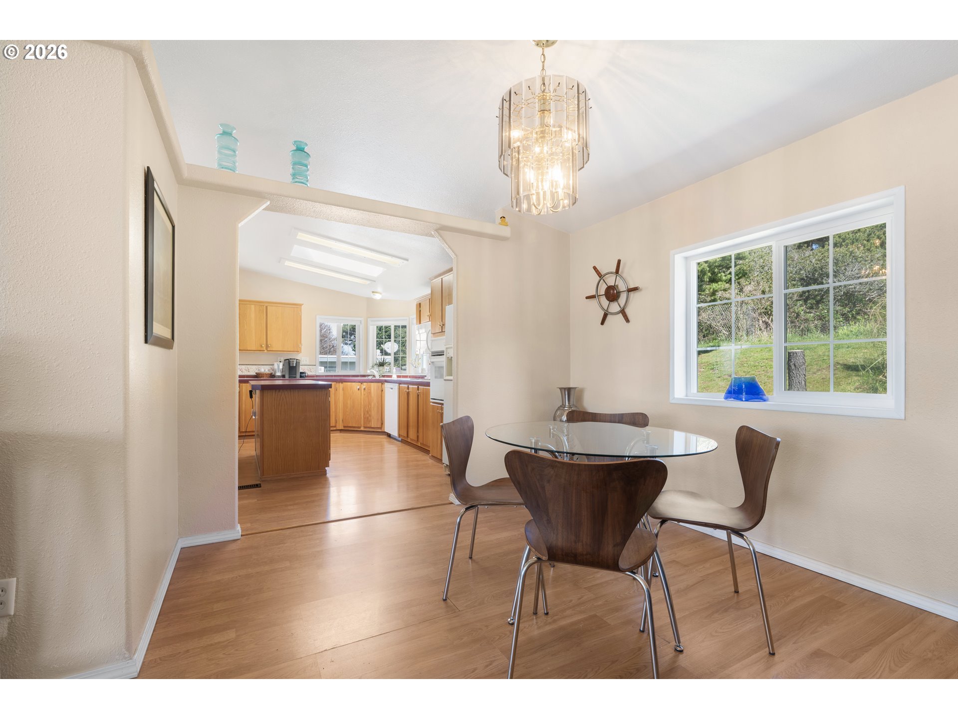 94033 Doyle Point Road Gold Beach, OR 97444 - Photo 15 of 42 a view of a dining room with furniture and chandelier