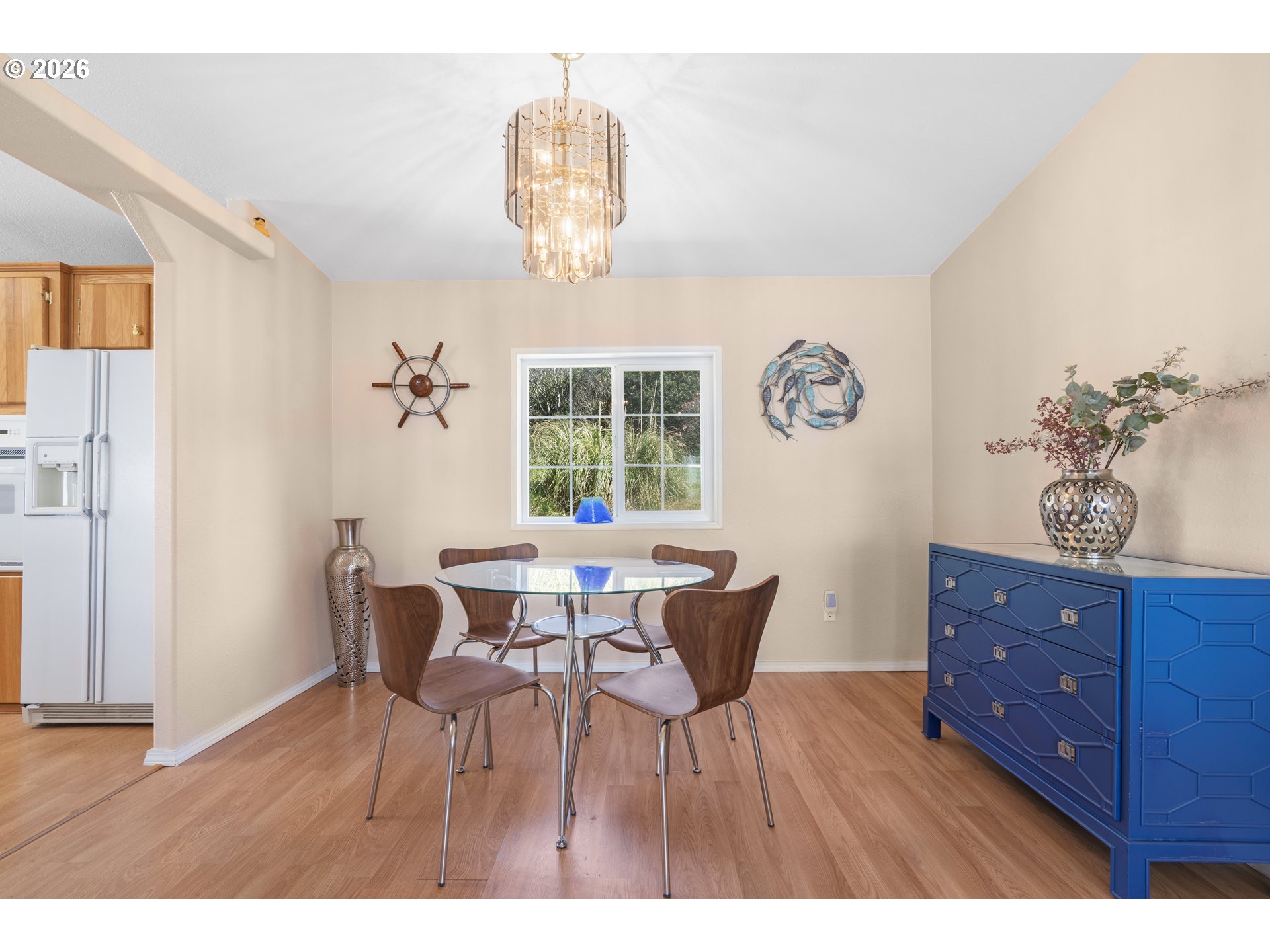 94033 Doyle Point Road Gold Beach, OR 97444 - Photo 16 of 42 a view of a dining room with furniture a chandelier and wooden floor