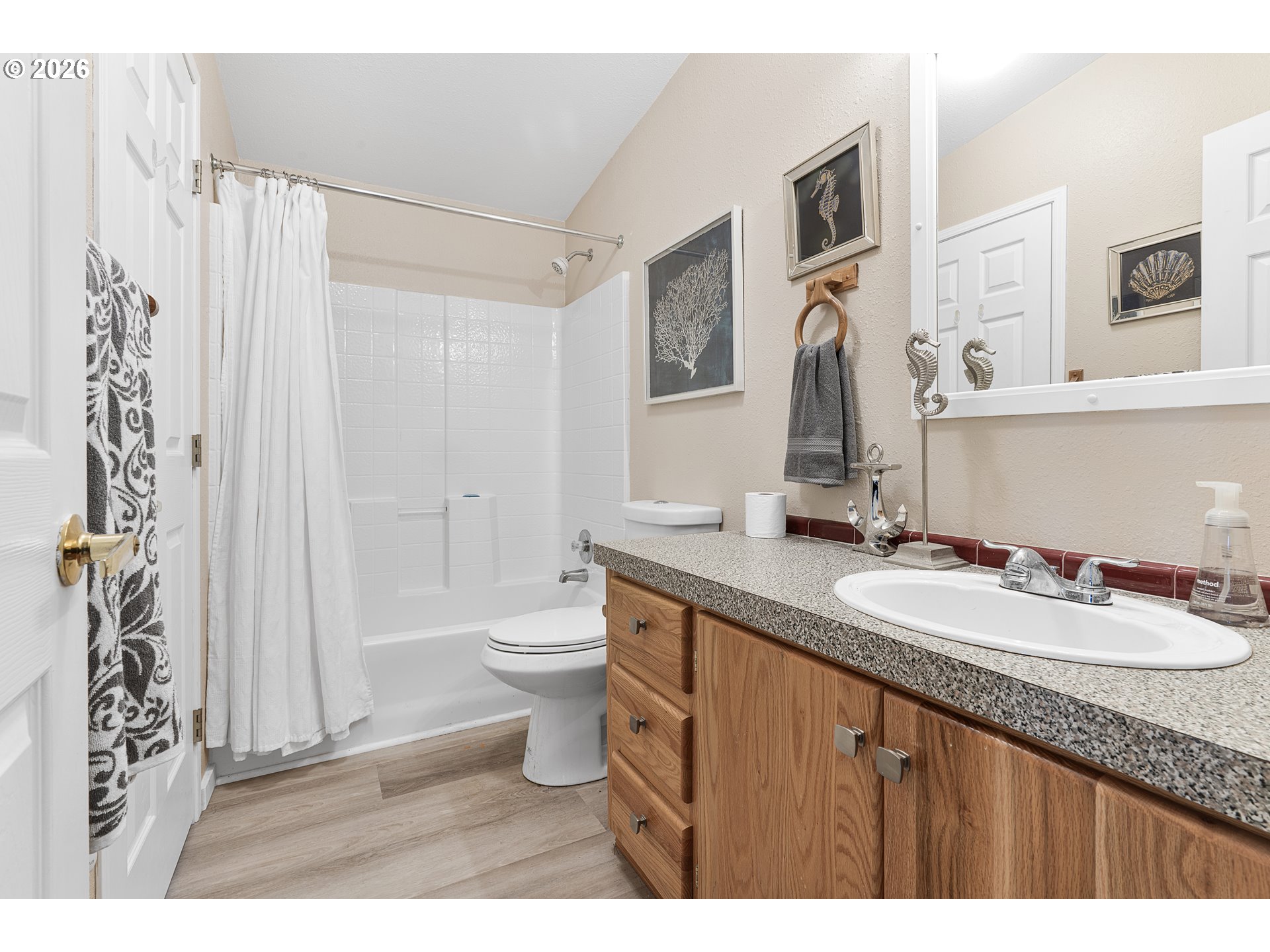 94033 Doyle Point Road Gold Beach, OR 97444 - Photo 31 of 42 a bathroom with a granite countertop sink toilet a mirror a vanity and shower