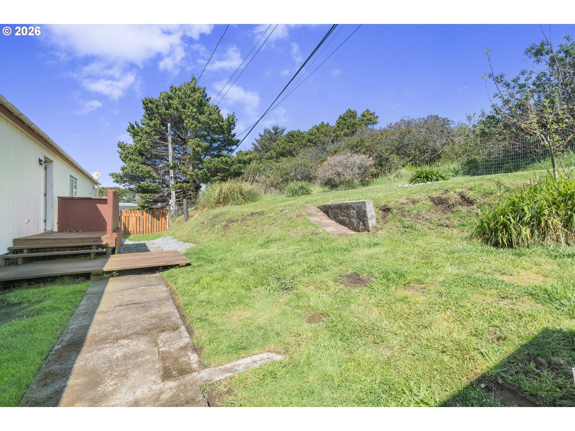 94033 Doyle Point Road Gold Beach, OR 97444 - Photo 34 of 42 a view of a backyard with wooden fence