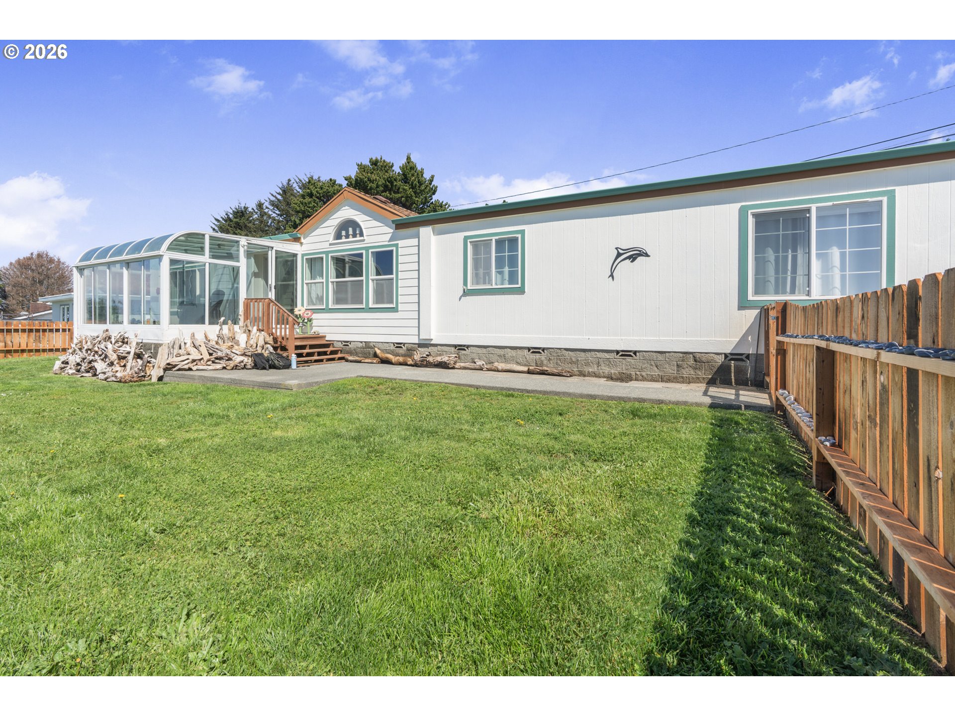 94033 Doyle Point Road Gold Beach, OR 97444 - Photo 36 of 42 a backyard of a house with table and chairs