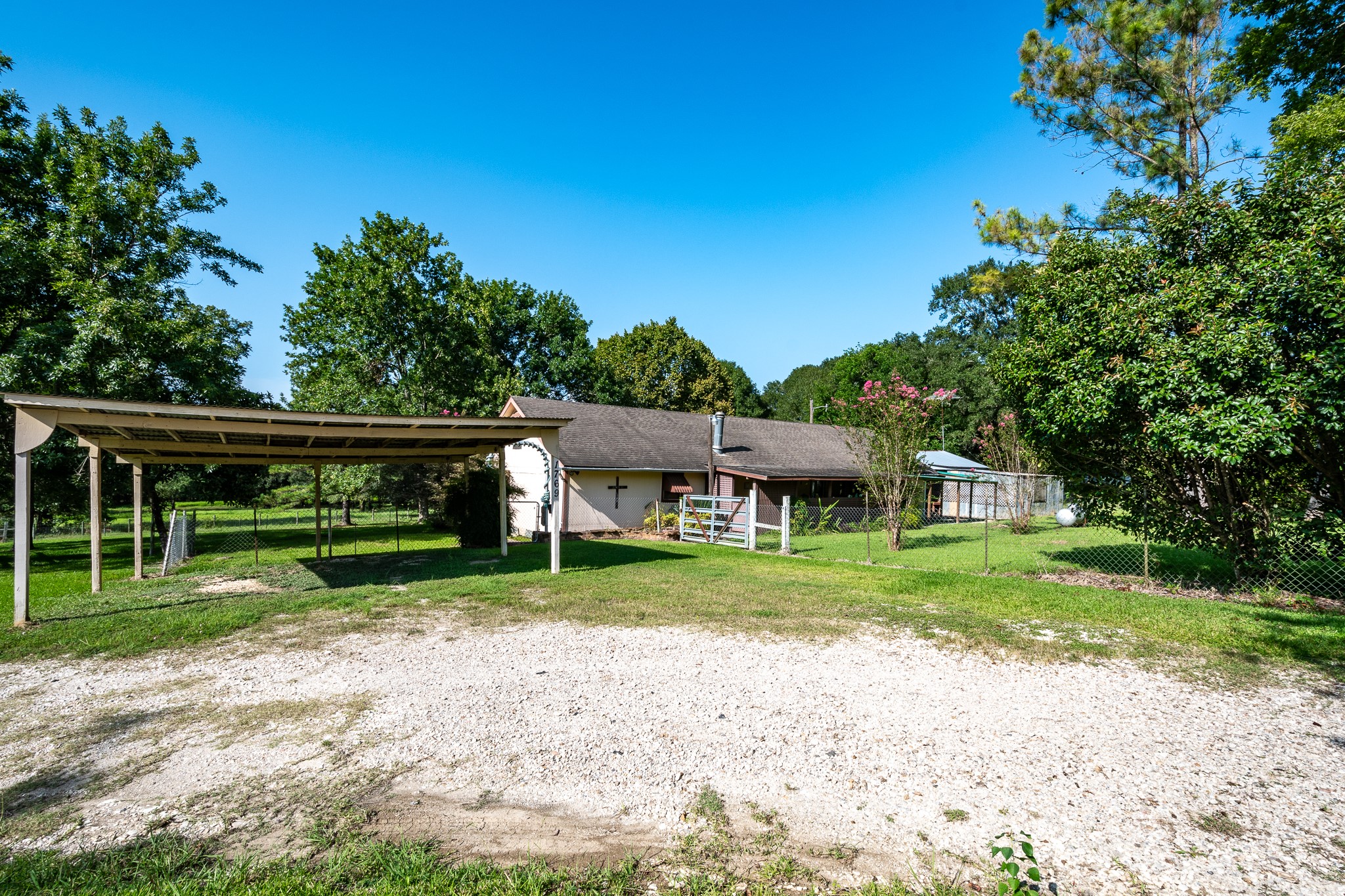 1713 Fm 2797 Dayton, TX 77535 - Photo 30 of 50 a view of a yard in front of a house with a large tree