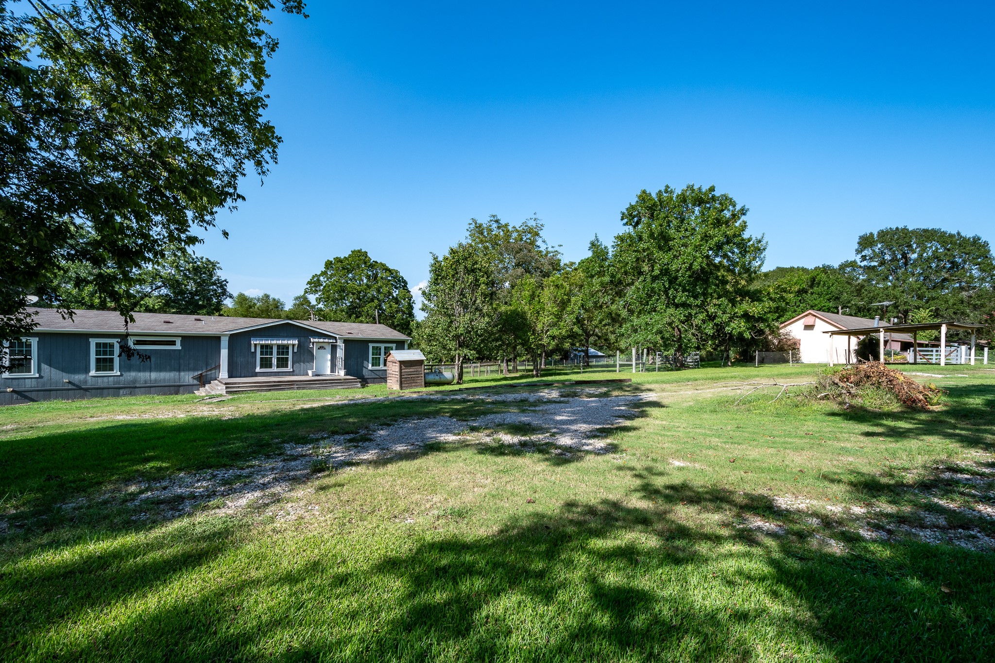 1713 Fm 2797 Dayton, TX 77535 - Photo 3 of 50 a view of a yard in front of a house with large trees