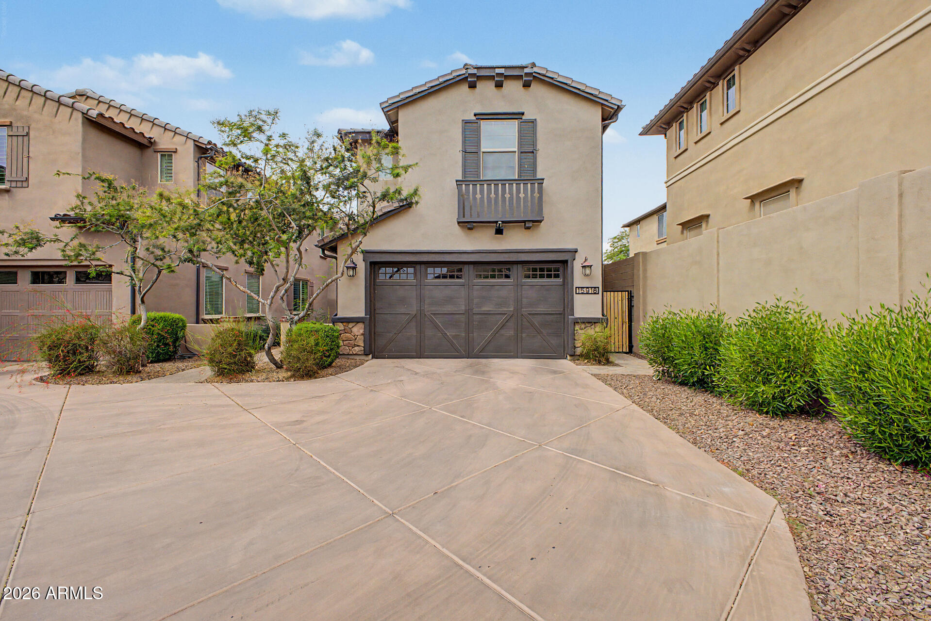 15918 South 11th Way Phoenix, AZ 85048 - Photo 2 of 32 a front view of a house with a yard and garage
