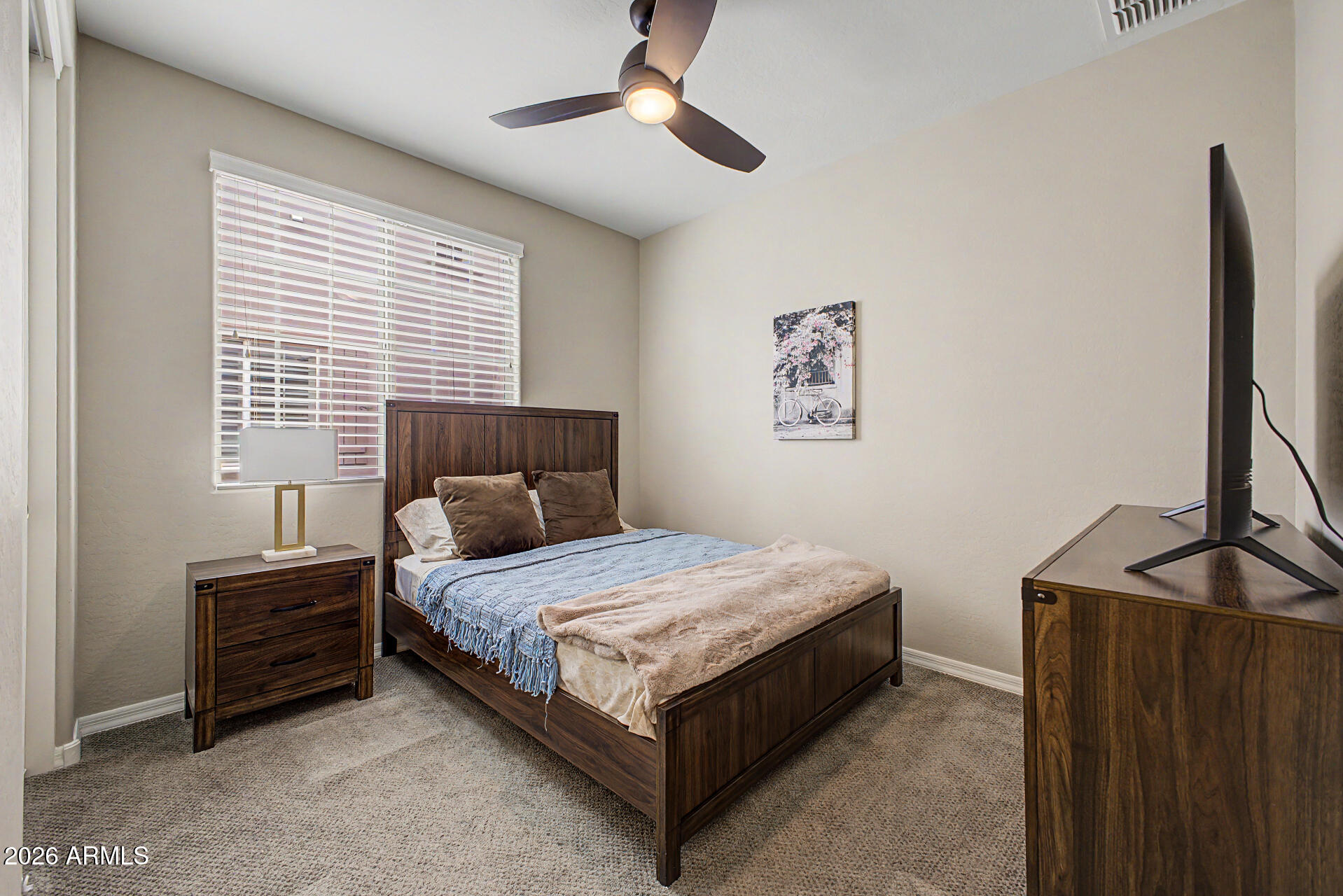 15918 South 11th Way Phoenix, AZ 85048 - Photo 21 of 32 a bedroom with a bed lamp and a window