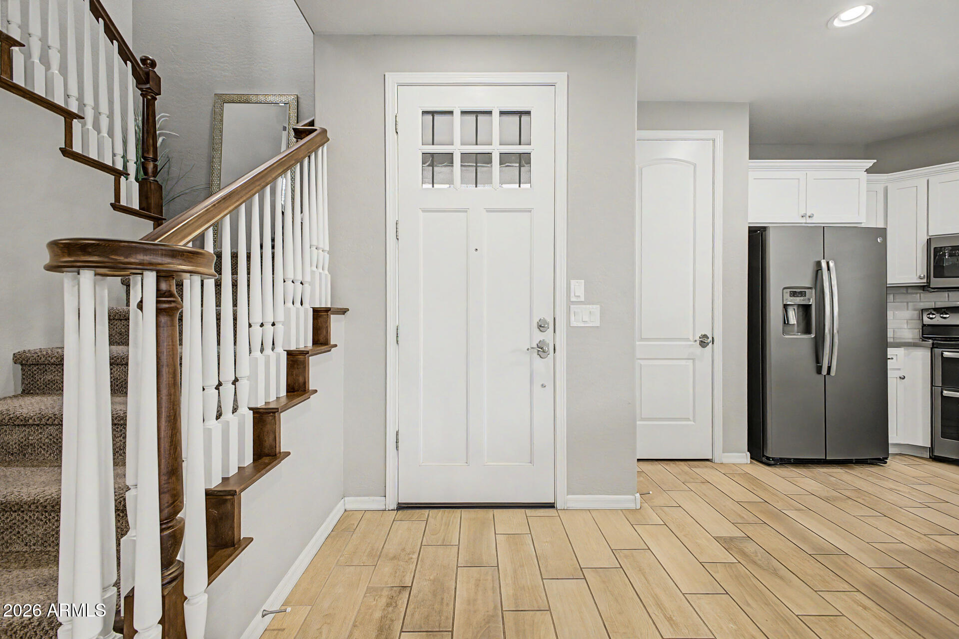 15918 South 11th Way Phoenix, AZ 85048 - Photo 3 of 32 a view of an entryway with wooden floor and staircase