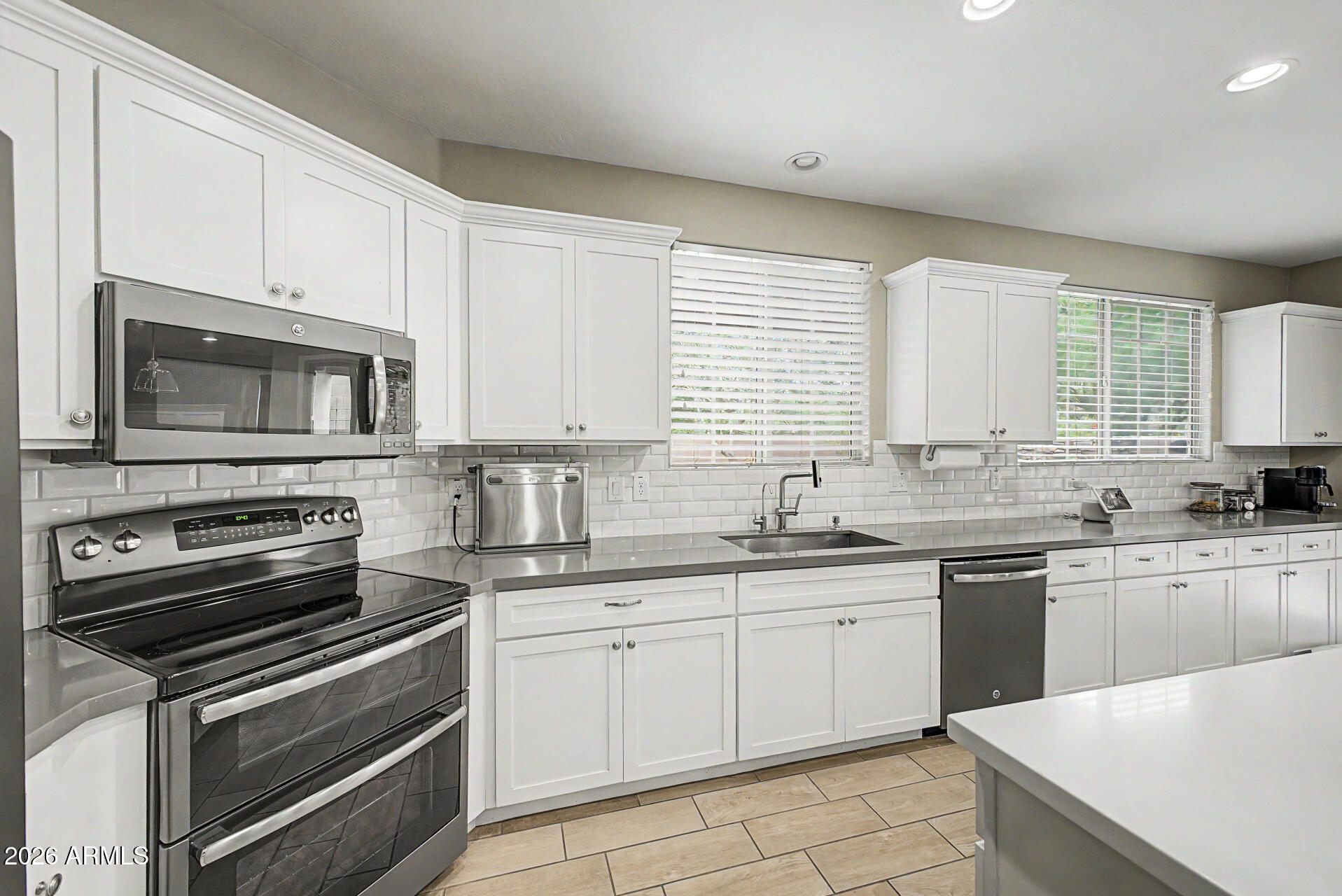 15918 South 11th Way Phoenix, AZ 85048 - Photo 9 of 32 a kitchen with a sink stove and microwave