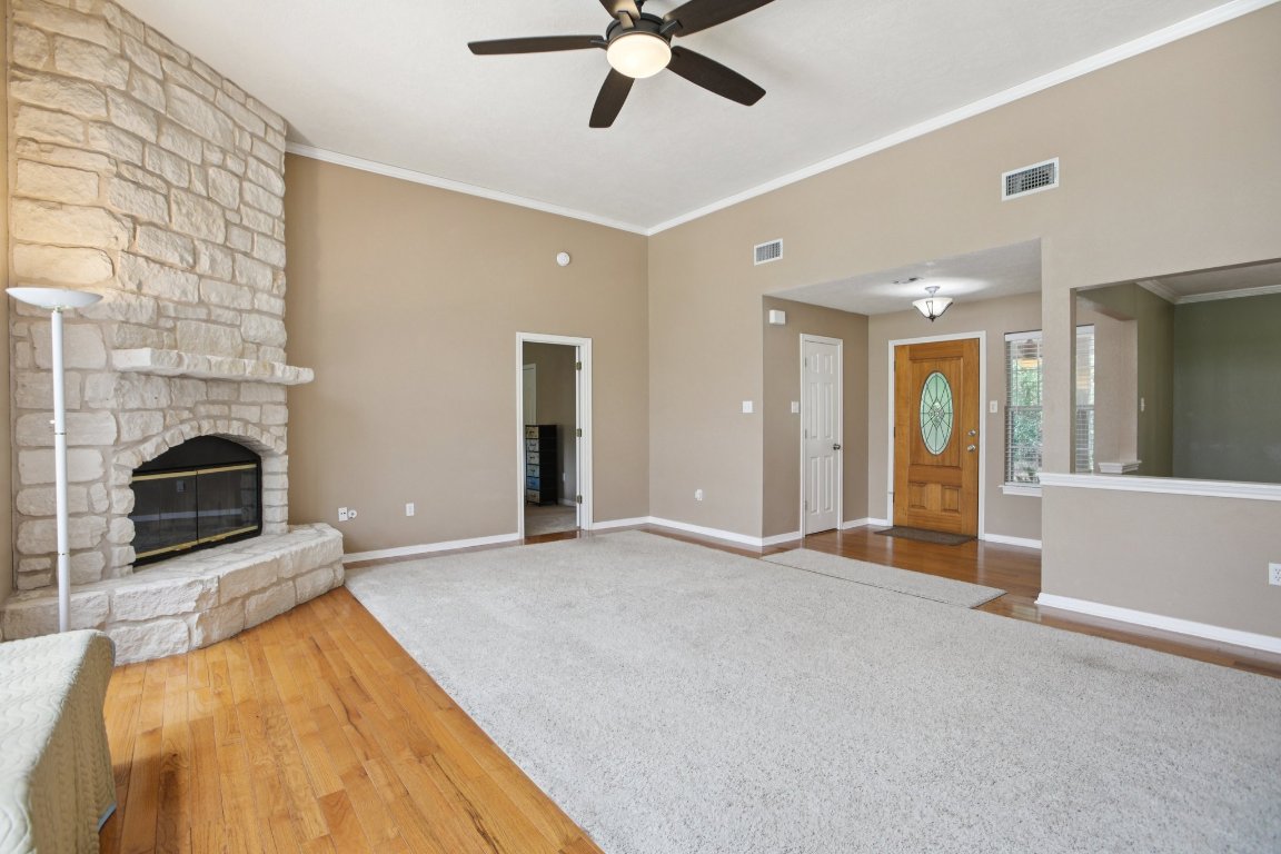 148 Oak Ridge Drive Cedar Creek, TX 78612 - Photo 10 of 40 a view of a livingroom with a fireplace and a ceiling fan
