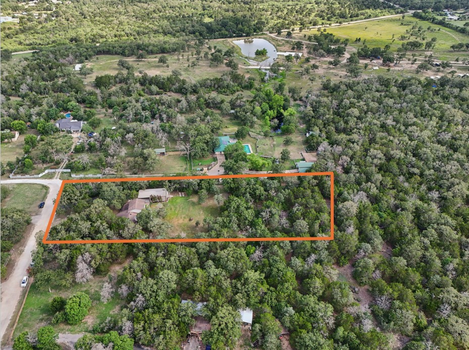 148 Oak Ridge Drive Cedar Creek, TX 78612 - Photo 2 of 40 an aerial view of a house with a yard and lake view