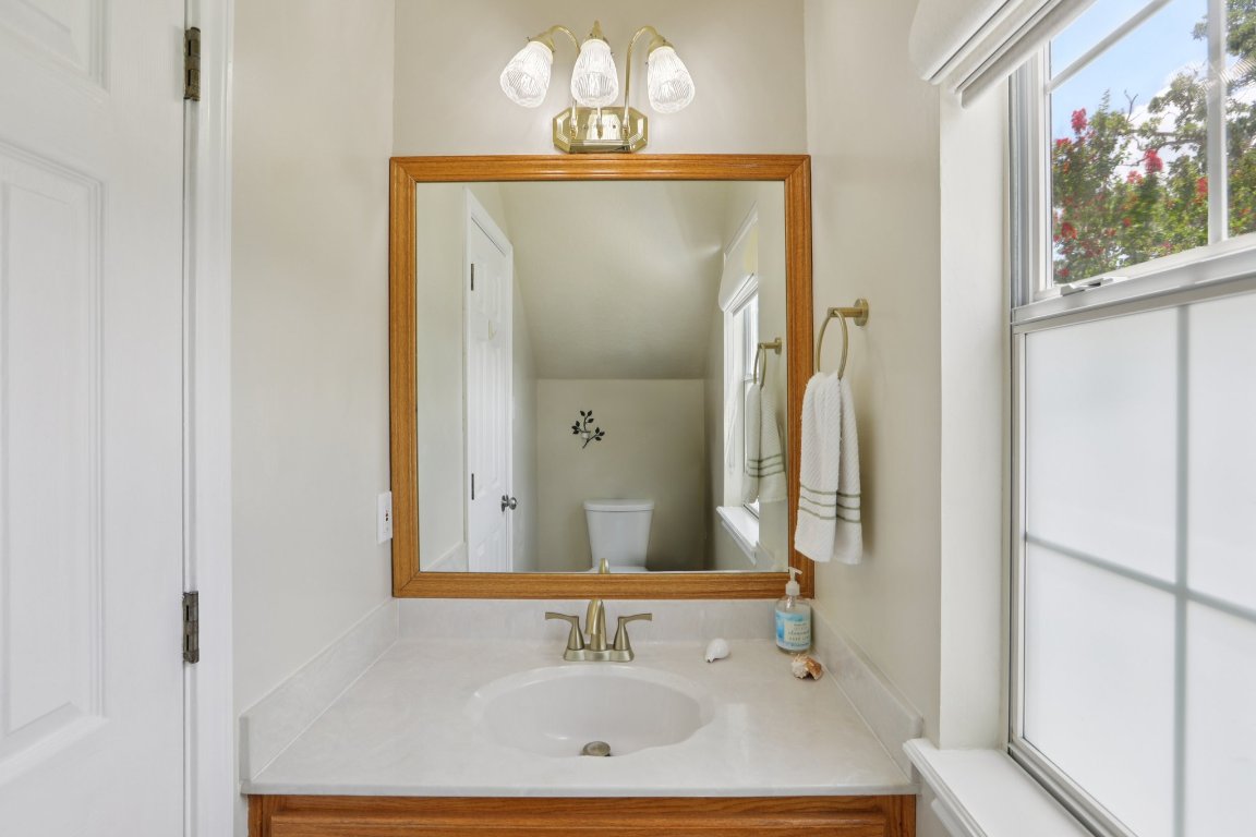 148 Oak Ridge Drive Cedar Creek, TX 78612 - Photo 23 of 40 a bathroom with a sink and a mirror
