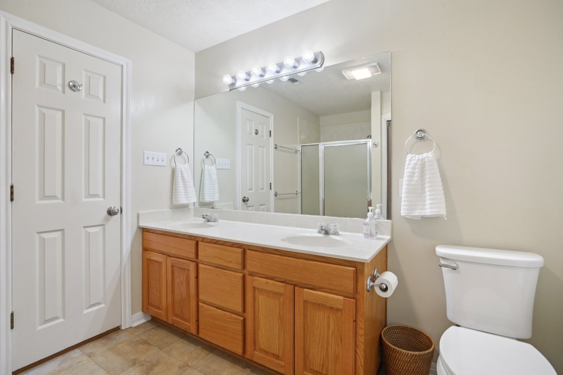 148 Oak Ridge Drive Cedar Creek, TX 78612 - Photo 27 of 40 a bathroom with a double vanity sink mirror and toilet