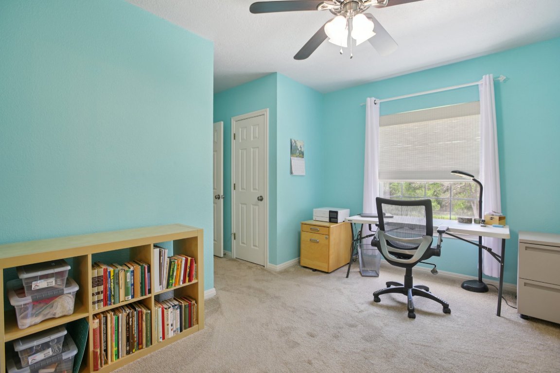 148 Oak Ridge Drive Cedar Creek, TX 78612 - Photo 33 of 40 a view of a workspace with furniture and a window