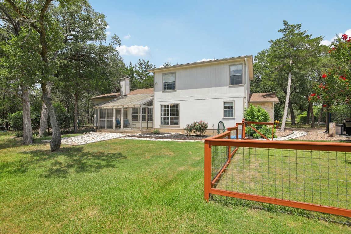 148 Oak Ridge Drive Cedar Creek, TX 78612 - Photo 35 of 40 a view of a house with pool and a yard