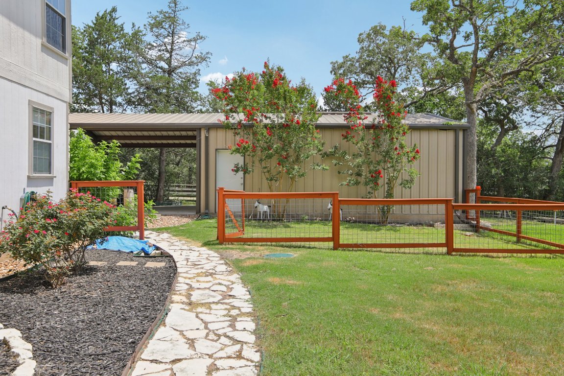 148 Oak Ridge Drive Cedar Creek, TX 78612 - Photo 36 of 40 a house view with a garden space