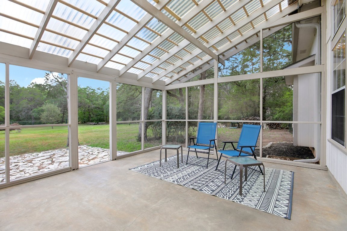 148 Oak Ridge Drive Cedar Creek, TX 78612 - Photo 6 of 40 a view of a deck with a table and chairs next to a yard