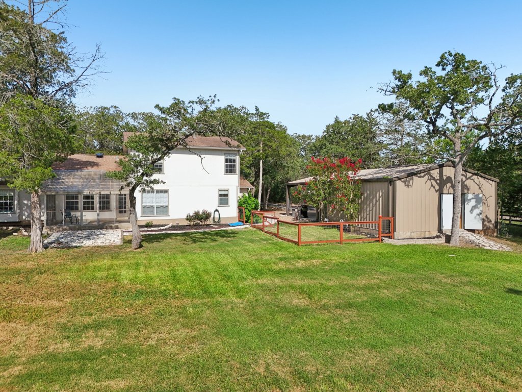 148 Oak Ridge Drive Cedar Creek, TX 78612 - Photo 7 of 40 a house view with a sitting space and garden