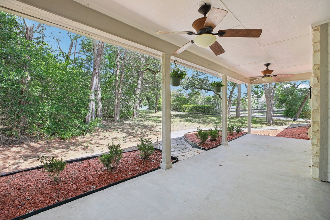 148 Oak Ridge Drive Cedar Creek, TX 78612 - Photo 9 of 40 a view of a porch with furniture and garden