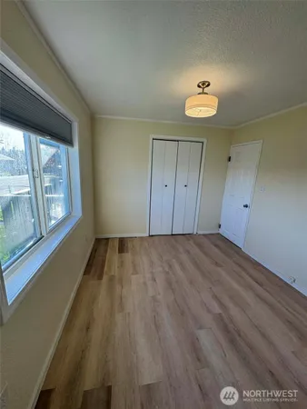 a view of a counter top space with kitchen island stainless steel appliances a sink and living room view