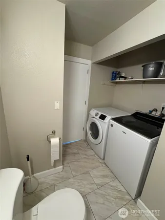 a kitchen with a refrigerator sink and cabinets